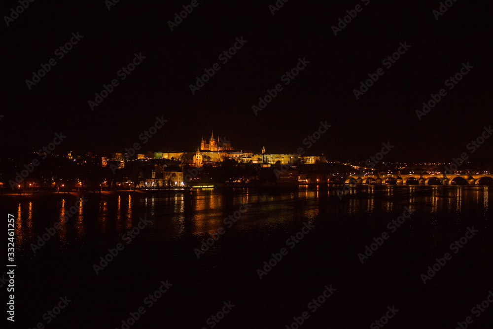 Night Prague. A view of the river, the Prague castle and the Charles bridge.