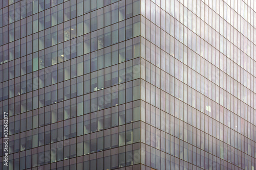 Abstract architecture. Glass blue square Windows of facade modern city business building skyscraper. The texture of the windows of the building.