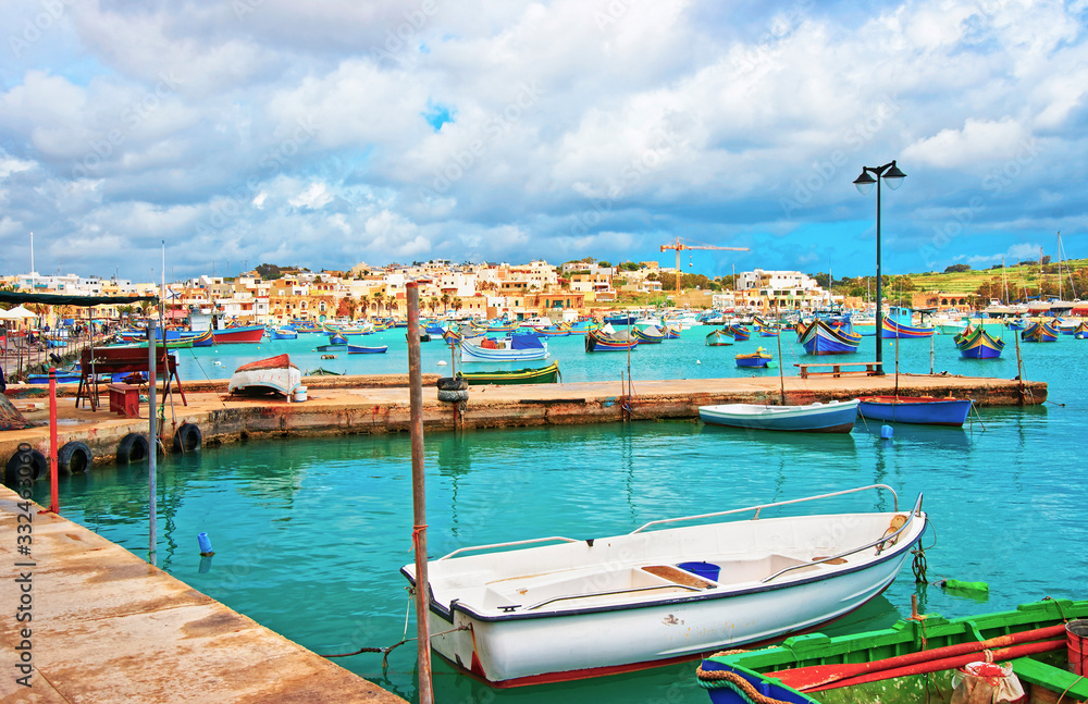 Luzzu boats in Marsaxlokk Port in Mediterranean sea Malta
