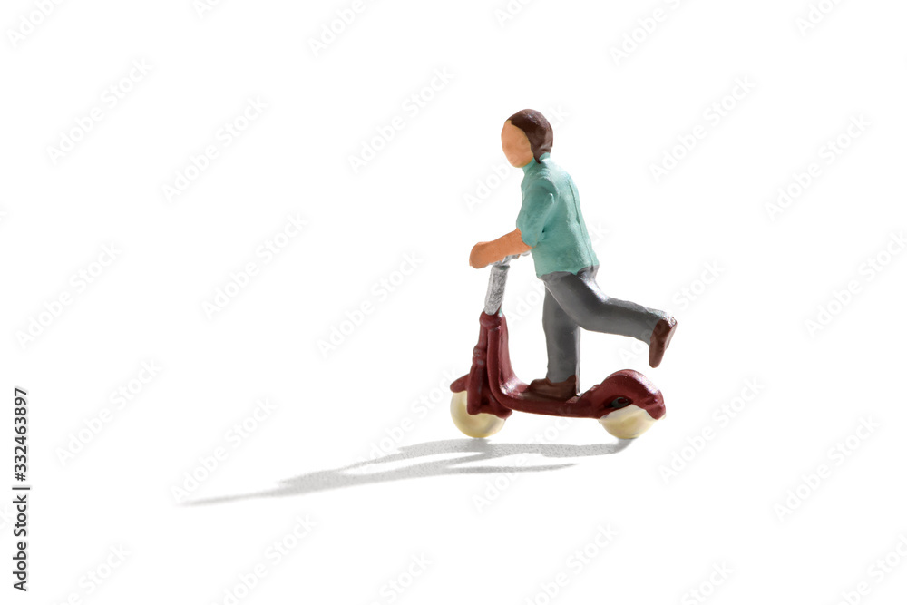 Naklejka premium Miniature figure of a child on a scooter