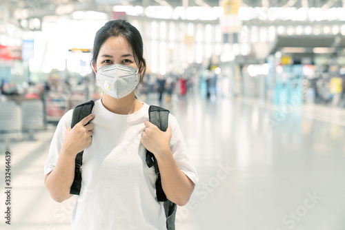 Portrait of asian woman with healthy face mark protect corona virus with airport terminal background. The coronavirus outbreak is disease 2019 (COVID-19) has spread to the world.