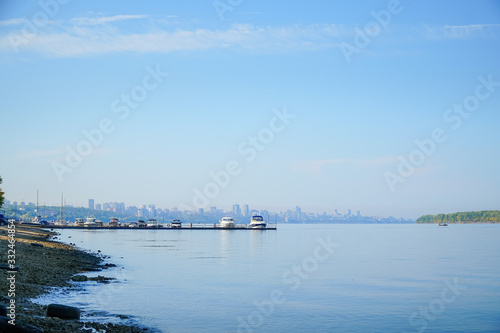 View of the big river, beyond which you can see the pier with boats and city. © pro2audio