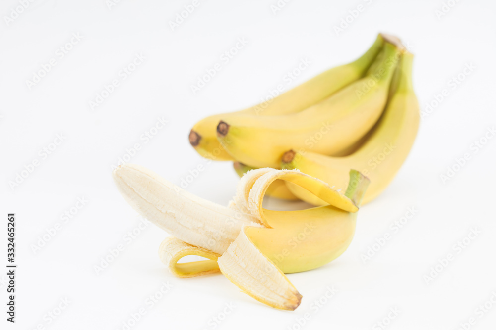 Fresh bananas isolated on white background. Bunch of ripe, sweet bananas., one half peeled.
