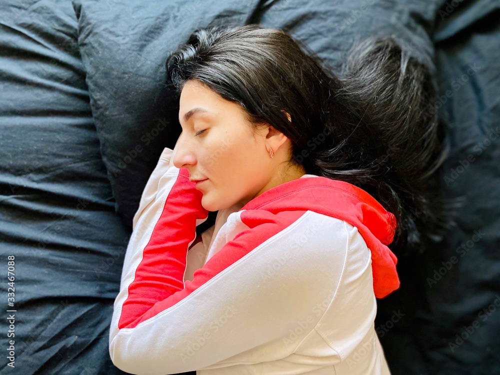 a girl in bed in quarantine time with a fever and running nose disinfecting her phone and camera a girl in bed in quarantine time with a fever and running nose disinfecting her phone and camera