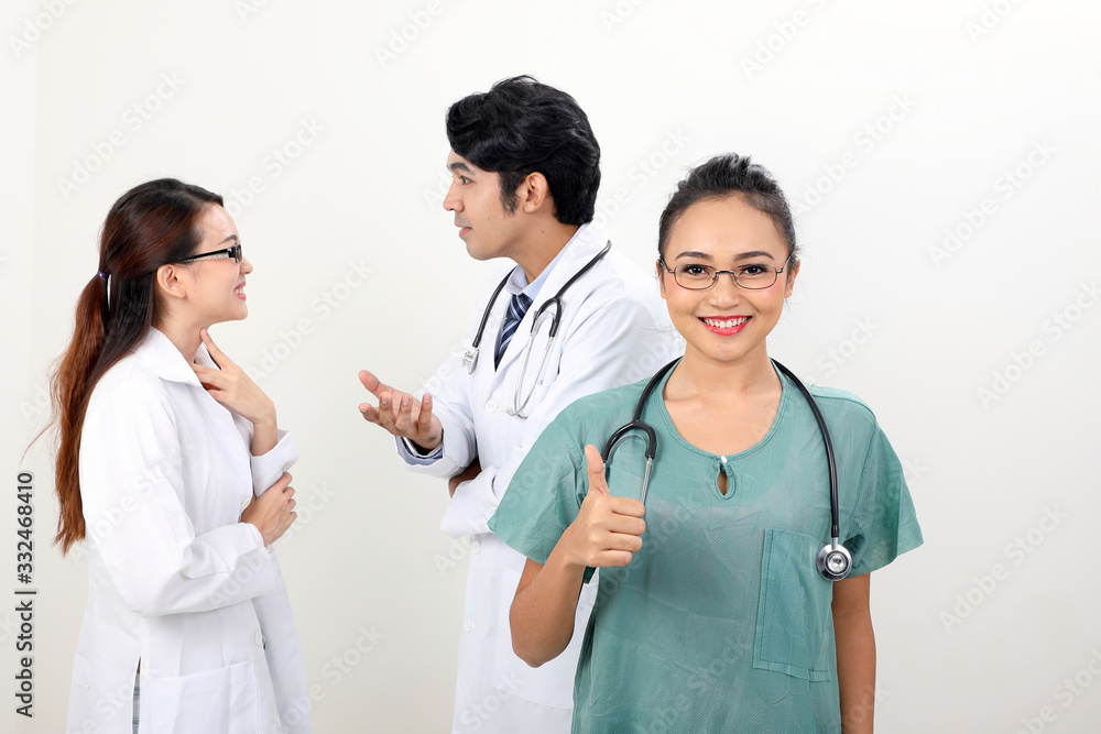 young asian malay chinese male female doctor on white background thumbs up looking at camera young asian malay chinese male female doctor on white background thumbs up looking at camera