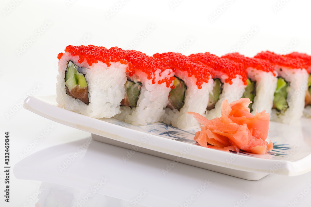 Japanese Cuisine - Appetizing Salmon Sushi Set. Philadelphia Sushi Roll - Maki Sushi with Philadelphia Cheese inside on mirror black background. Smoked salmon rolls served on a plate