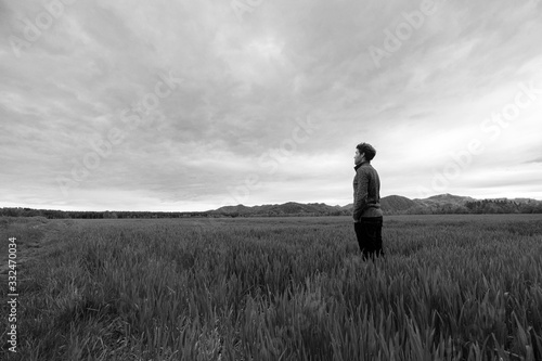 Young man standing in meadow