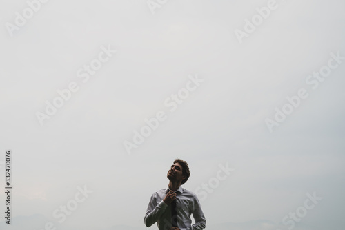 Young businessman loosening his tie