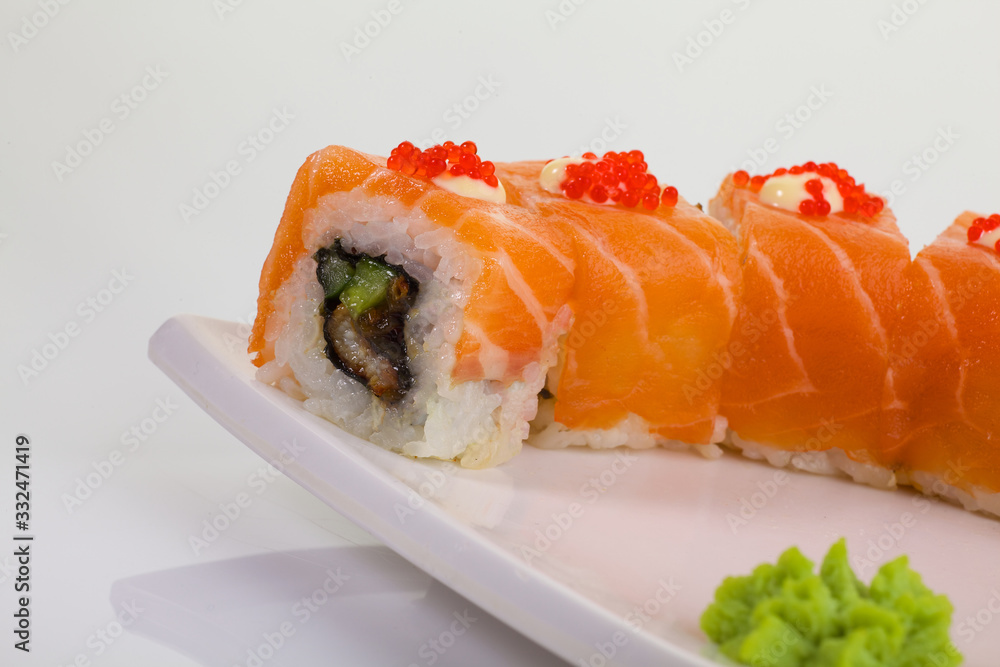 Japanese Cuisine - Appetizing Salmon Sushi Set. Philadelphia Sushi Roll - Maki Sushi with Philadelphia Cheese inside on mirror black background. Smoked salmon rolls served on a plate Japanese Cuisine - Appetizing Salmon Sushi Set. Philadelphia Sushi Roll - Maki Sushi with Philadelphia Cheese inside on mirror black background. Smoked salmon rolls served on a plate
