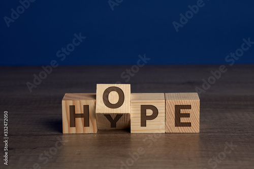 Words HYPE and HOPE written on blocks of wood. The word HOPE goes over the word HYPE. photo