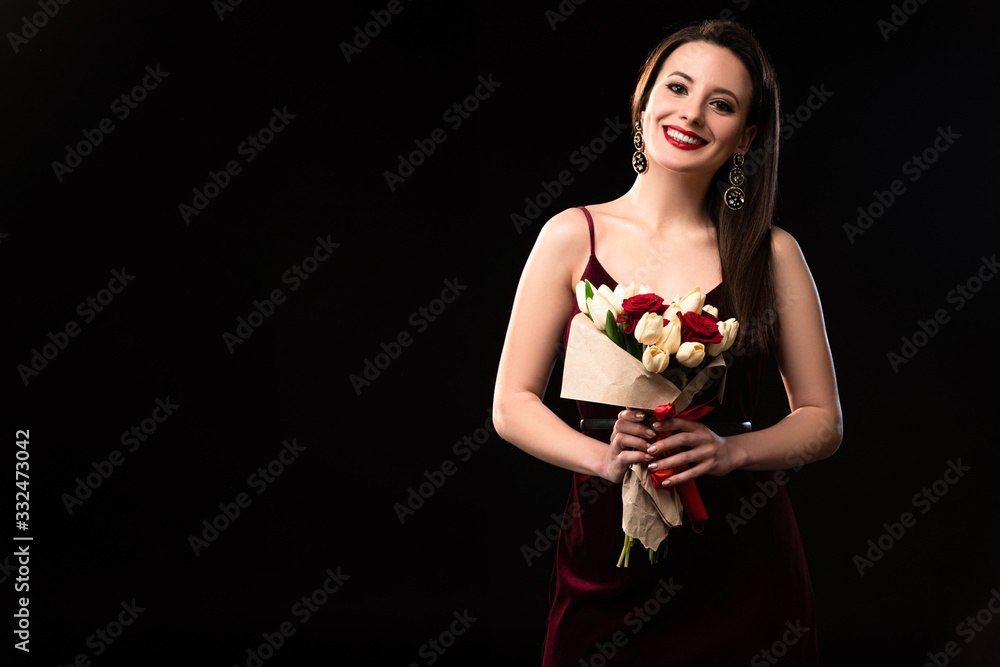 smiling woman in dress holding bouquet isolated on black smiling woman in dress holding bouquet isolated on black