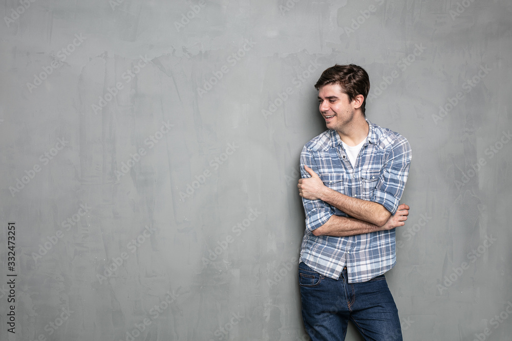young man standing on a concrete wall young man standing on a concrete wall
