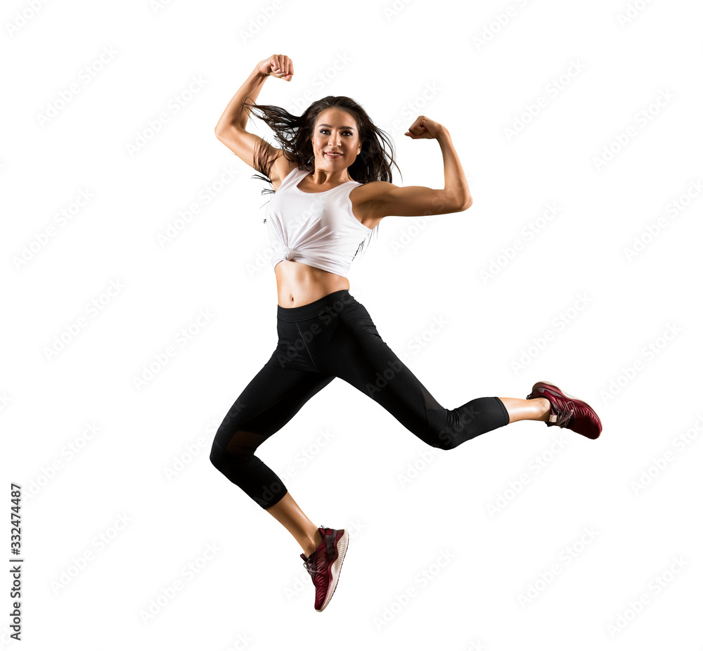 Sporty woman jumping on white background