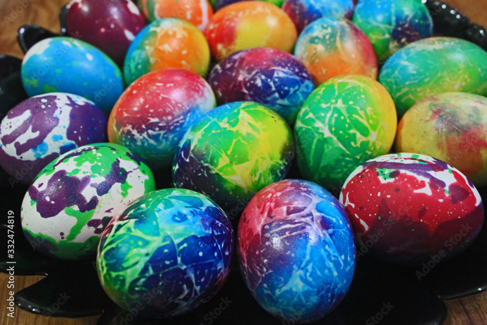 Colorful Easter eggs placed on black plate Colorful Easter eggs placed on black plate