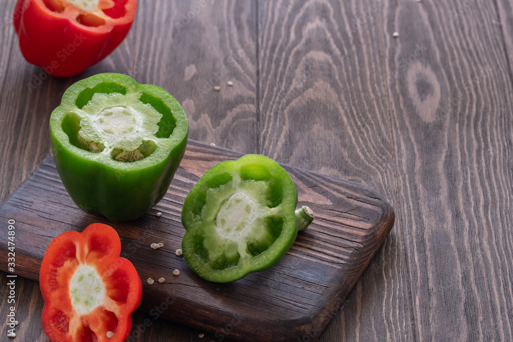 Fresh sweet red and green peppers on a wooden table Fresh sweet red and green peppers on a wooden table