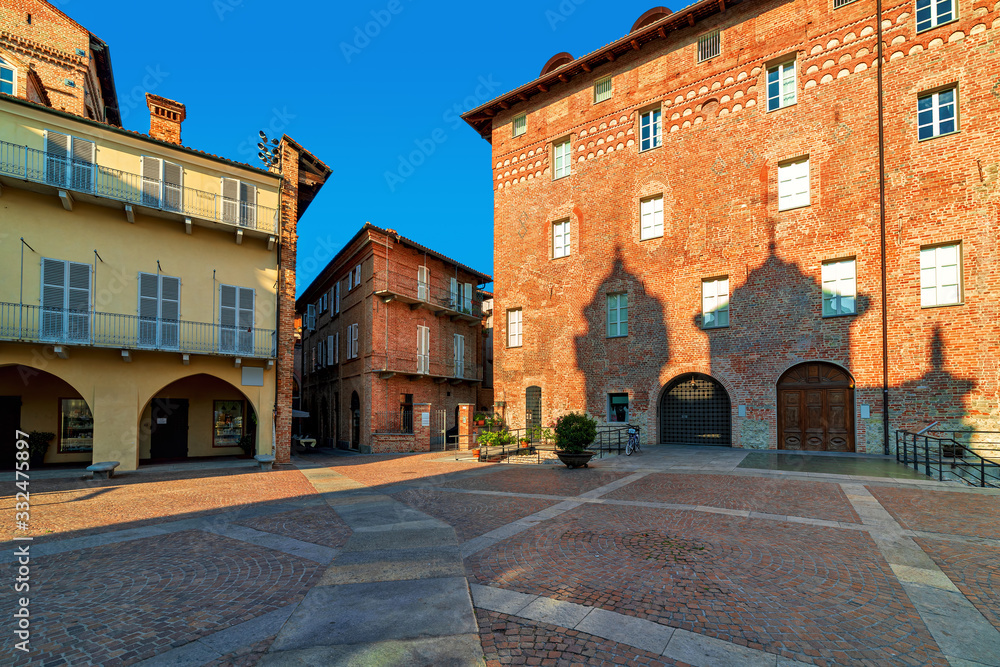 Old houses on small cobblestone square in Alba, Italy.