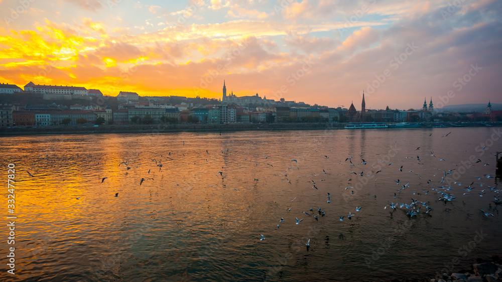 Danube river and historic buildings at sunset in Budapest, Hungary