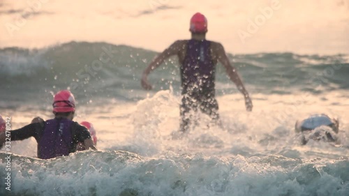 Slow-motion of female athlete swimming against the big waves