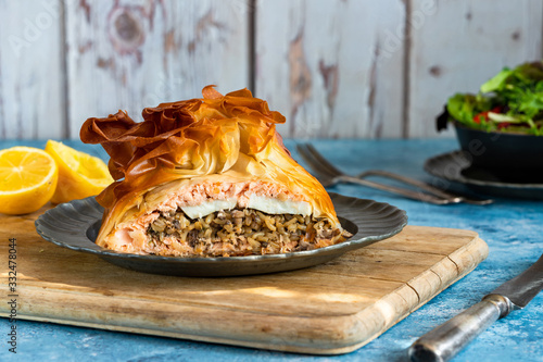 Coulibiac - Russian type of pirog filled with salmon stuffed with rice, mushrooms,onion,dill and hard-boiled egg photo