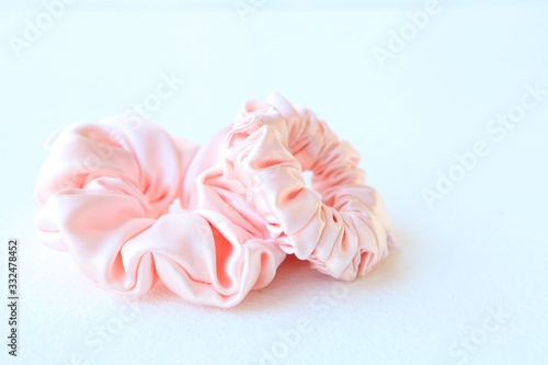 Pink silk Scrunchy isolated on white background. Flat lay Hairdressing tool of Colorful Elastic Hair Band, Bobble Scrunchie Hairband
