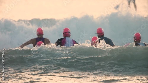 Slow-motion of female athlete swimming against the big waves