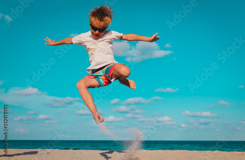 happy boy play on beach, kid enjoy sea vacation
