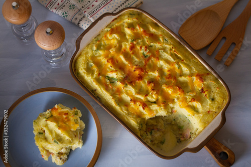 Creamy fish pie: salmon, cod, smoked coley, creamy sauce and cheesy potato topping. View from above, top view