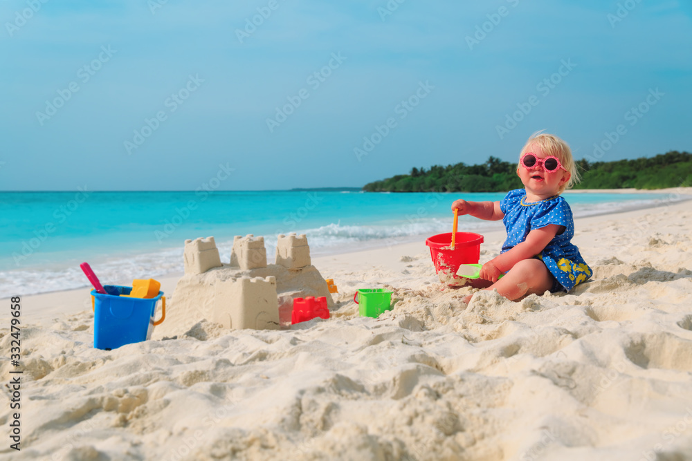 cute little girl play with sand on beach cute little girl play with sand on beach
