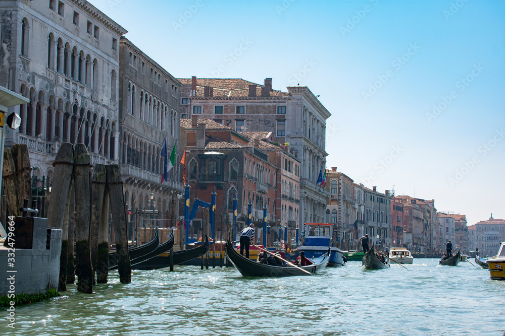 San Marco / Venice / Italy - April 17, 2019: View of Grand Canal with tourists in gondolas and old colorful buildings