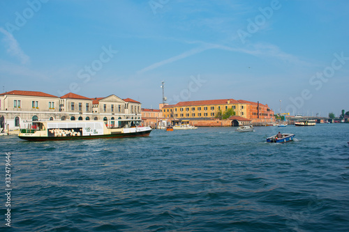 San Marco / Venice / Italy - April 17, 2019: View of canal with tourists in boat and old colorful buildings