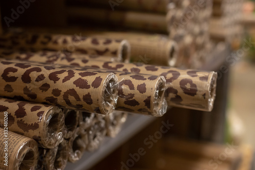 Brown wrapping paper rolls with trended animal print texture, selective focus