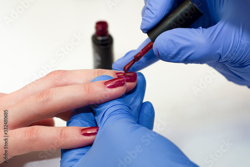 Wallpaper Mural manicure specialist covers the nails with red varnish Torontodigital.ca
