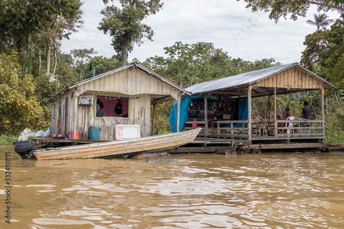 floating house in the amazon river © Eduardo