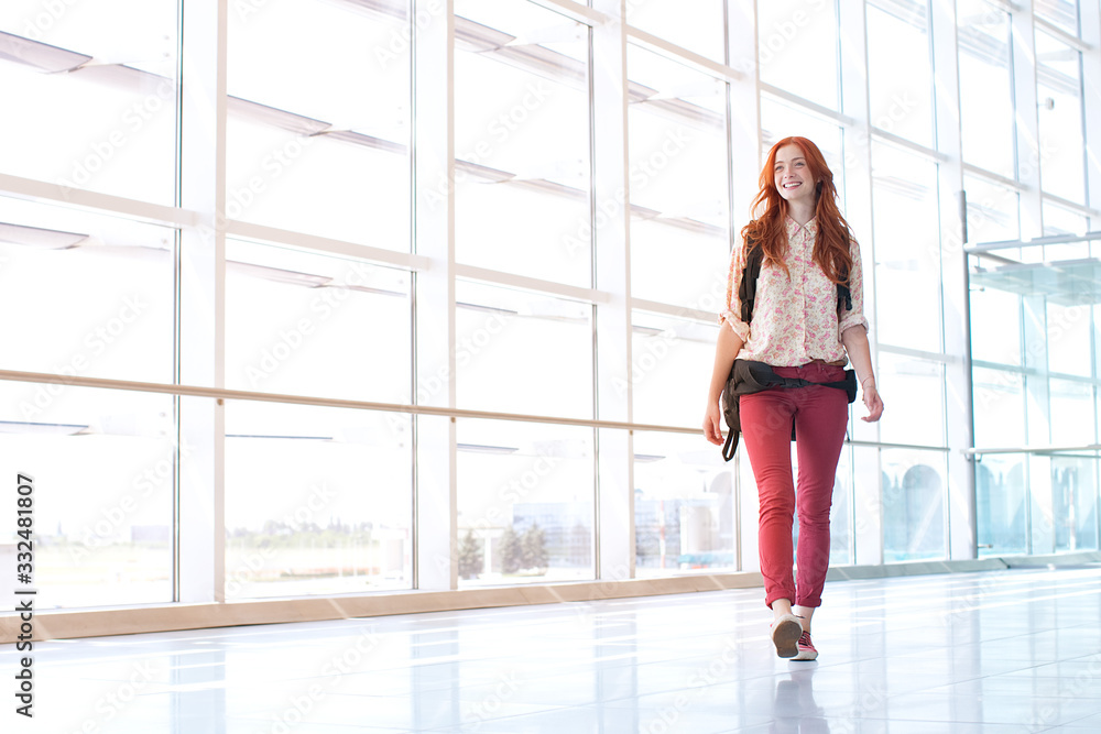 Young woman walking at airport. Young woman walking at airport.