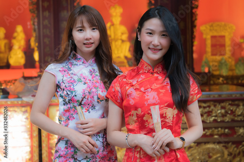 Portrait of Chinese girls wearing Chinese clothes holding paper folding fan in her hand