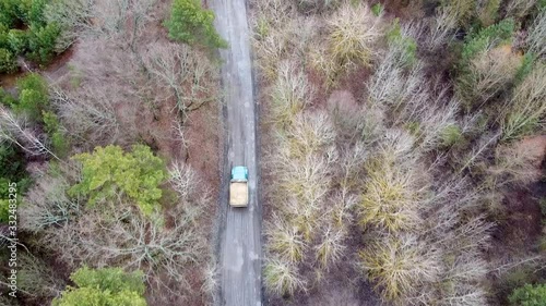 Aerial view of off-road industrial truck riding in a dirt road photo