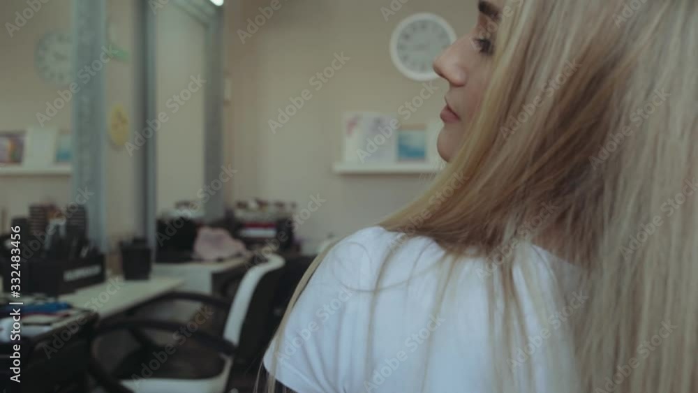 portrait of beautiful woman smiling at camera in beauty salon. turning around in chair portrait of beautiful woman smiling at camera in beauty salon. turning around in chair