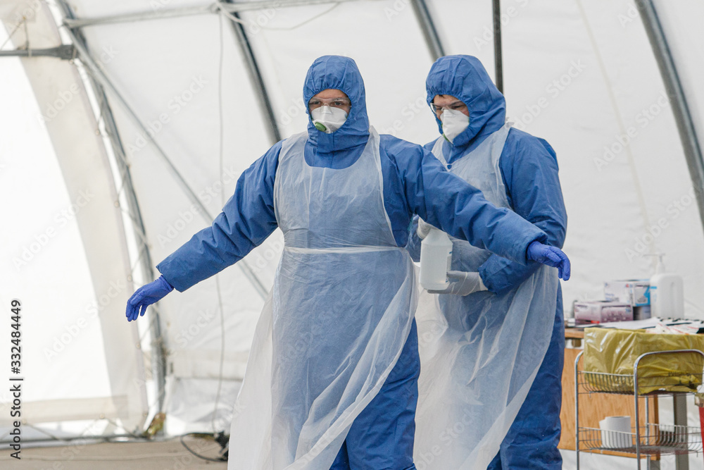 Coronavirus checkpoint. Medics with protective costumes take samples of blood for coronavirus (Covid-19) Coronavirus checkpoint. Medics with protective costumes take samples of blood for coronavirus (Covid-19)