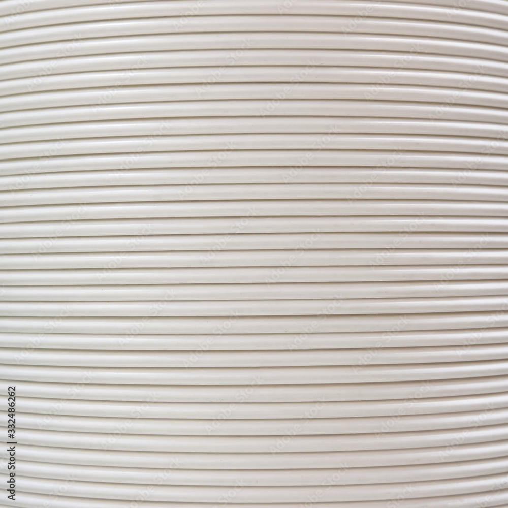 Background of white corrugated pipe. Texture of corrugation rings close-up Background of white corrugated pipe. Texture of corrugation rings close-up