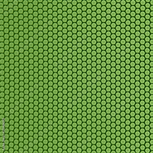 Grid of round holes, close-up green background