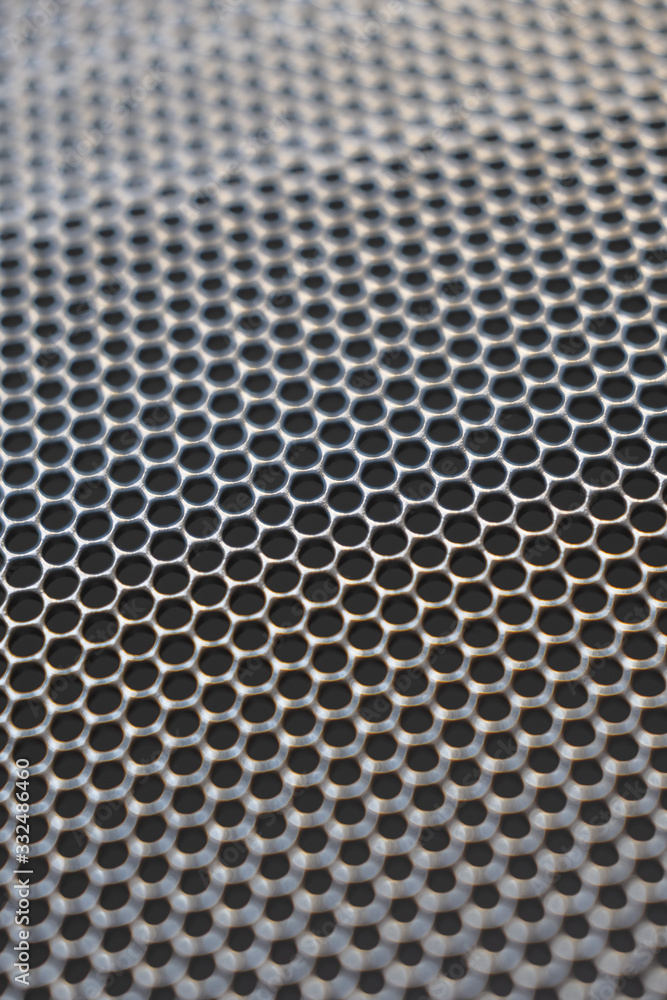 Background metal surface with round lattice holes, texture Background metal surface with round lattice holes, texture