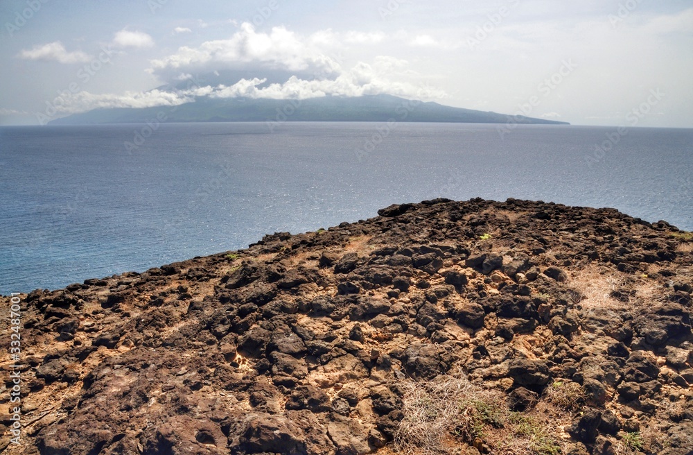 The Island of Brava lays quietly dunder the clouds as seen from the islet of Djeu, part of the Republic of Cabo Verde