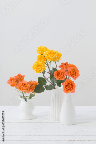 roses in white vase on white background