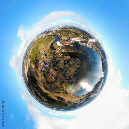 A three dimensional panoramic view of hydroelectric power generation plant and Ankkapurha Industrial Museum at Kymijoki river, Finland in a mini planet panorama style. photo