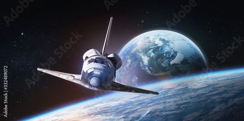Space shuttle on orbit of the Earth. Light and blue planet. View from space station. Elements of this image furnished by NASA