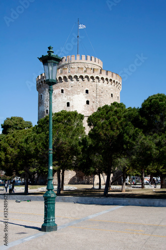 Street lamp in front of white tower of Thessaloniki on a spring day