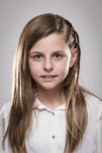 Wallpaper Mural Studio portrait of a cute girl with long blonde hair wearing a white shirt against neutral background Torontodigital.ca