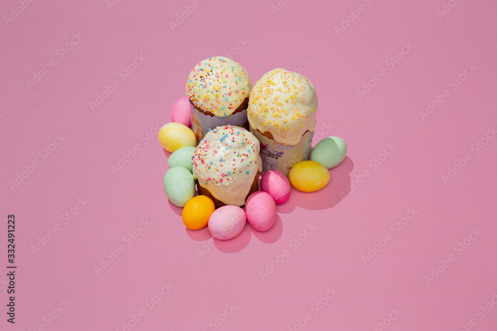 Easter cake and colorful eggs on a plate and pink background Easter cake and colorful eggs on a plate and pink background