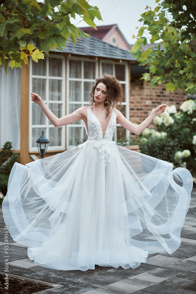Fototapeta premium Beautiful bride. Woman waving dress. Sexy girl with professional make up