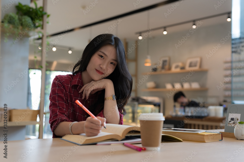 Close up of young business woman big smiling from ear to ear while holding tablet in her hand at table, successful concept Close up of young business woman big smiling from ear to ear while holding tablet in her hand at table, successful concept
